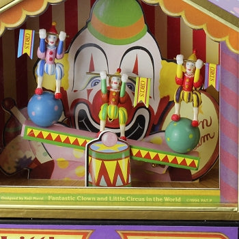 Boite à musique clown sur balançoire